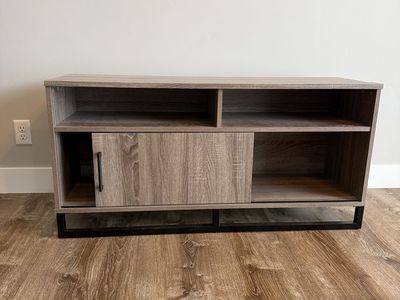Modern Farmhouse TV Stand / Media Console with Sliding Barn Door, Wood Grain Finish, Black Metal Base