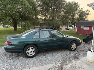 Green Chevrolet Lumina Sedan with Roof Rack