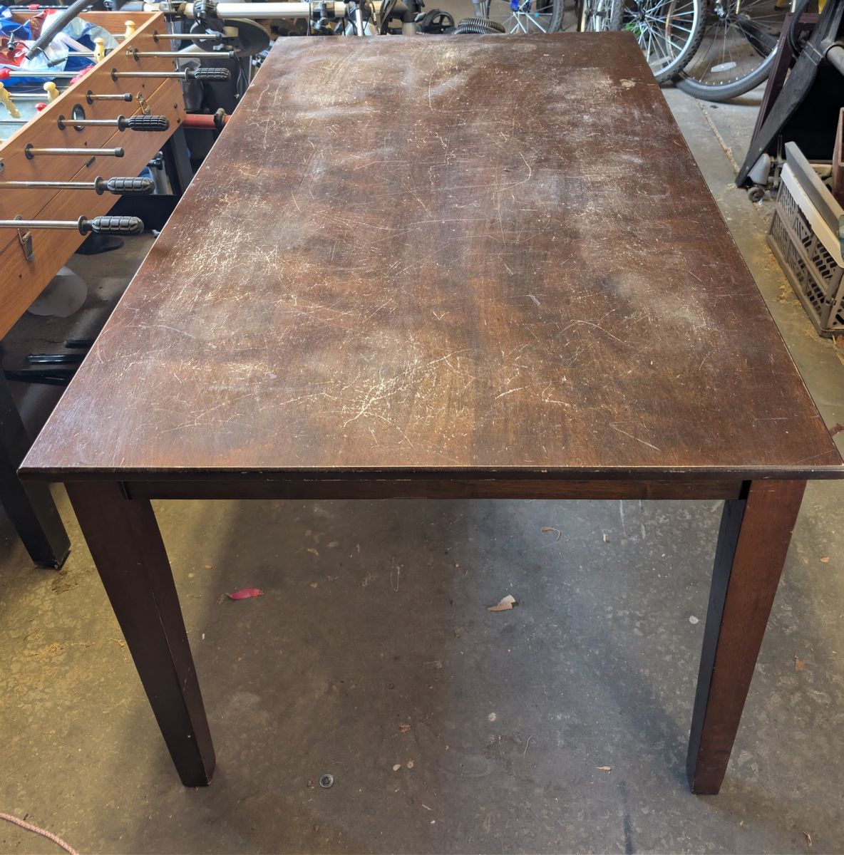 Wooden Dining Table - Distressed Dark Wood Finish, Sturdy Construction.