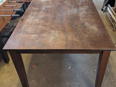 Wooden Dining Table - Distressed Dark Wood Finish, Sturdy Construction.