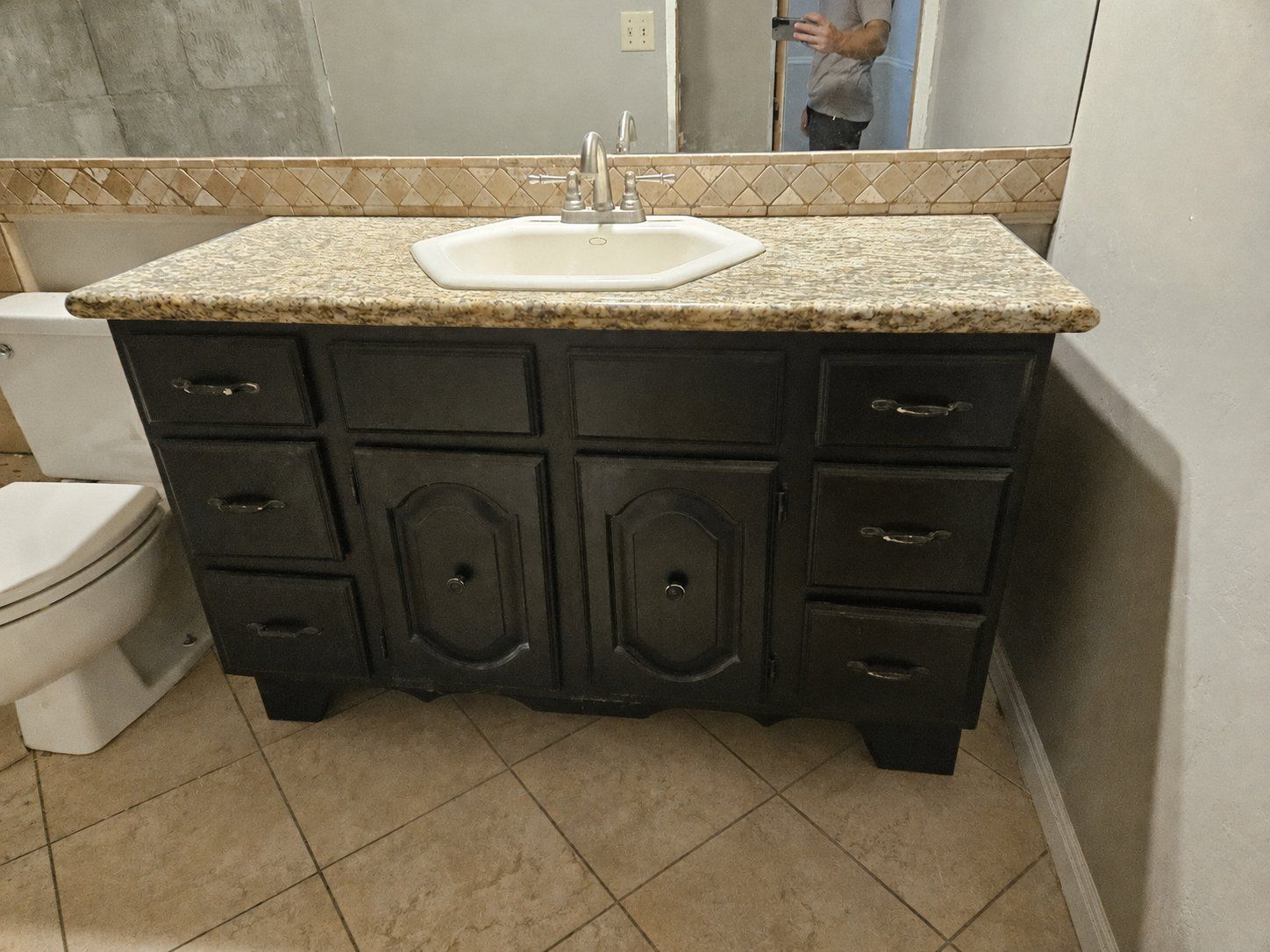 Black Vanity with Granite Countertop and Hexagon Sink