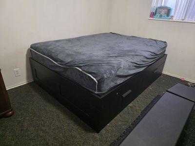 Queen bed with sliding drawers underneath