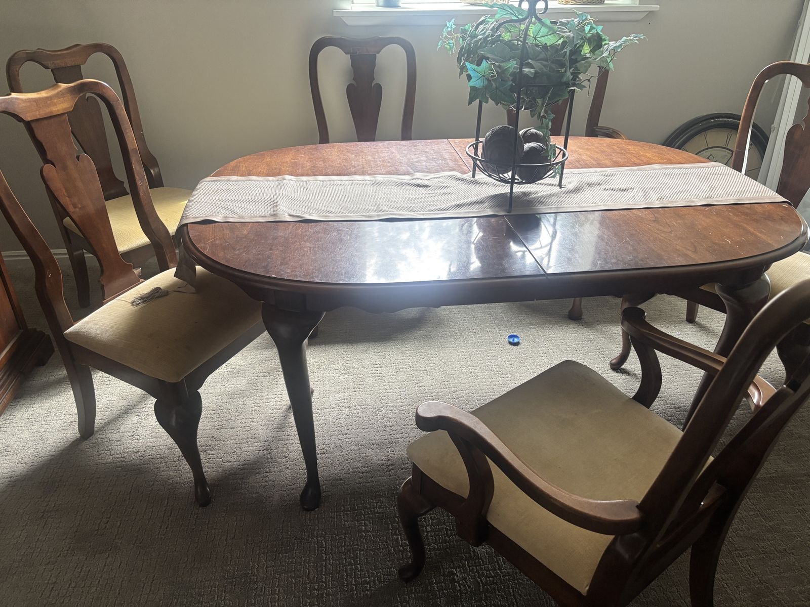 Five foot six inch traditional dining room table with 6 padded chairs.