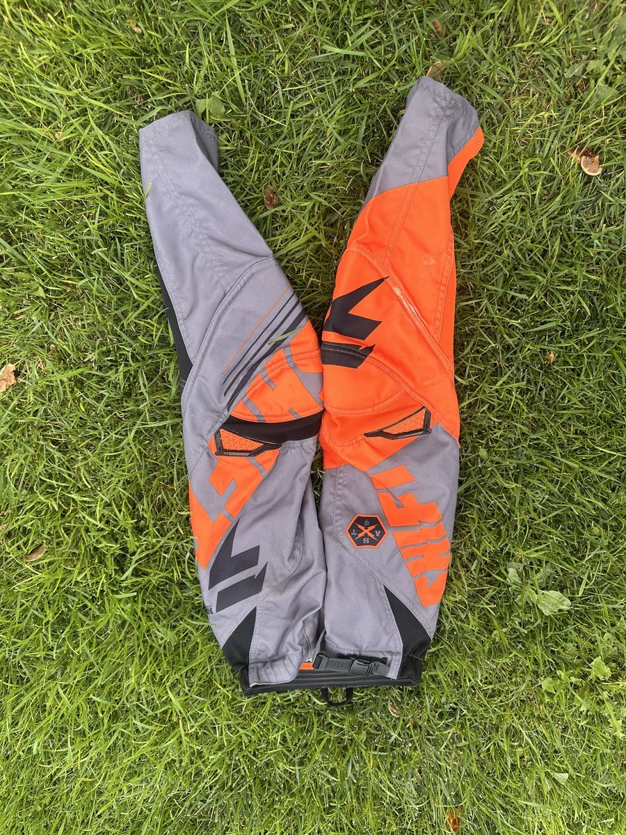 Shift youth size 8 with a 24 inch waist grey/black/orange motocross pants