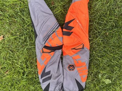Shift youth size 8 with a 24 inch waist grey/black/orange motocross pants
