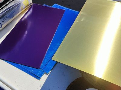 Engraving stock, 12 inches by 24 inches, (1 foot by 2 feet), pieces of brass plated steel sheet metal, with engravable coloring.