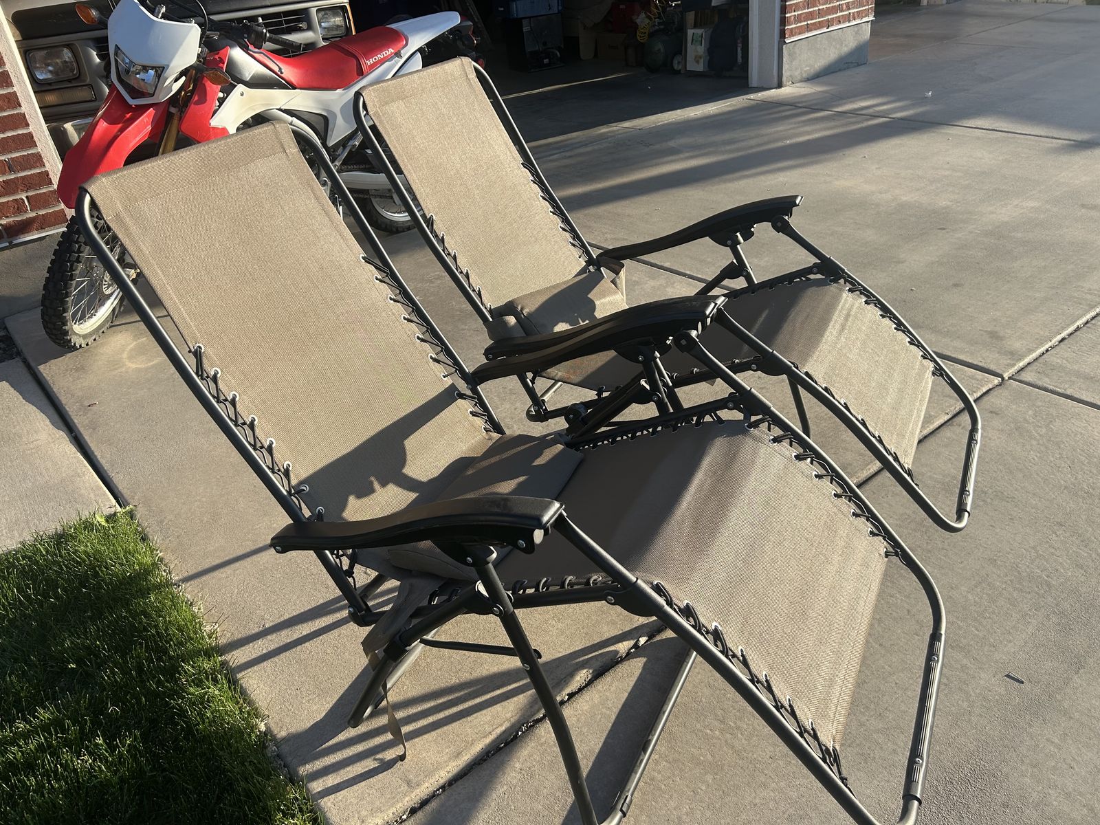 two outdoor reclining lounge chairs