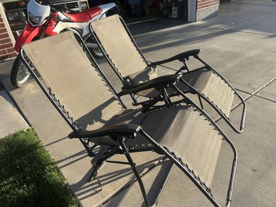 two outdoor reclining lounge chairs