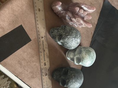 Crystal carved dragon, head, and skulls