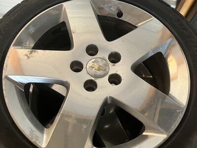 Chevy rims with tires and lug nuts. 215/50R17