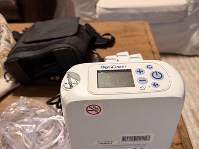 OxyGo Next Portable Oxygen Concentrator with 3 Batteries, Charger, Bag, and (Tubing new).