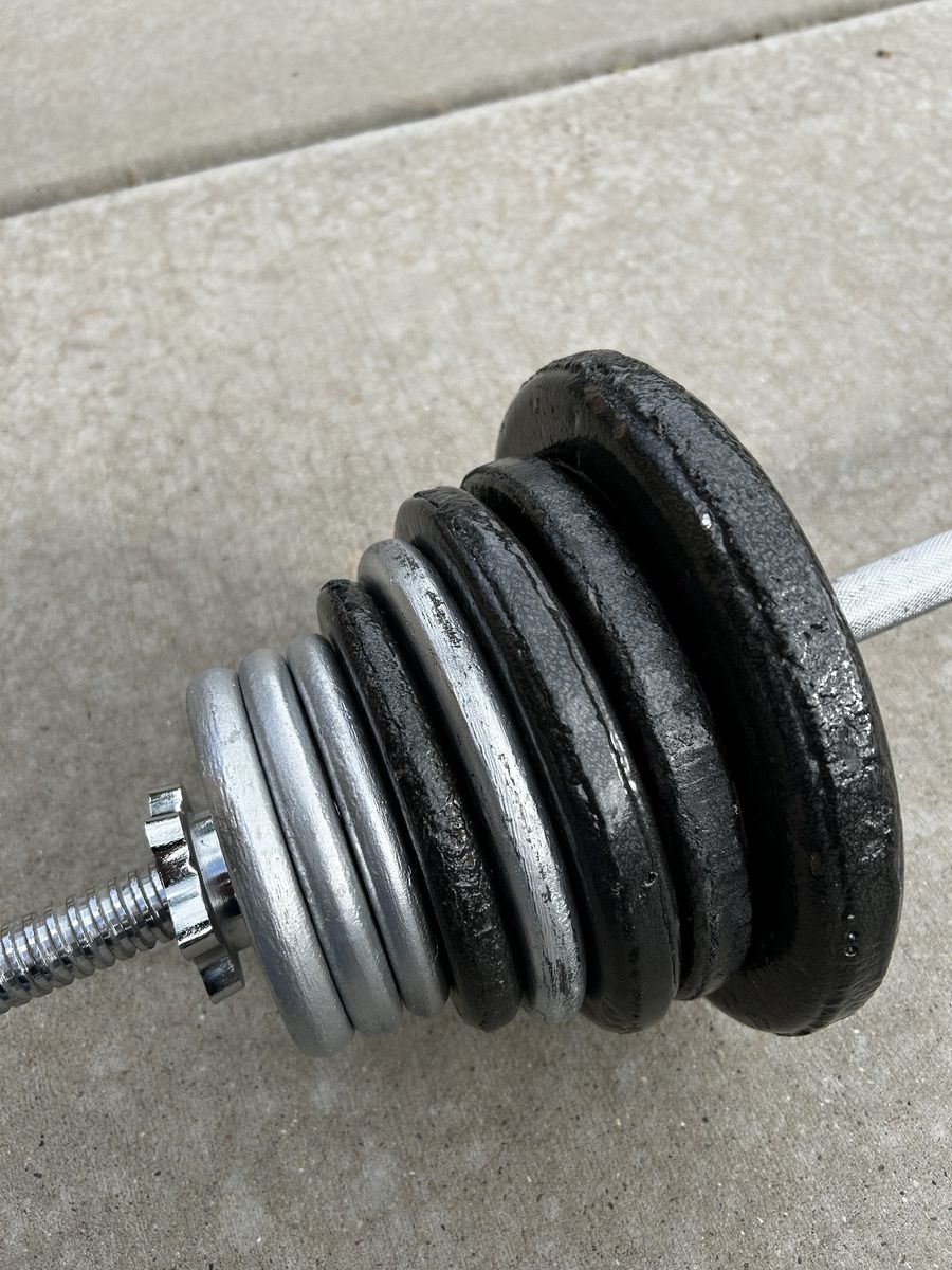 80 Pounds of Plate Weights Plus 5 Pound Bar