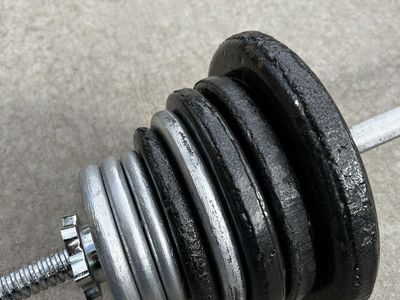 80 Pounds of Plate Weights Plus 5 Pound Bar