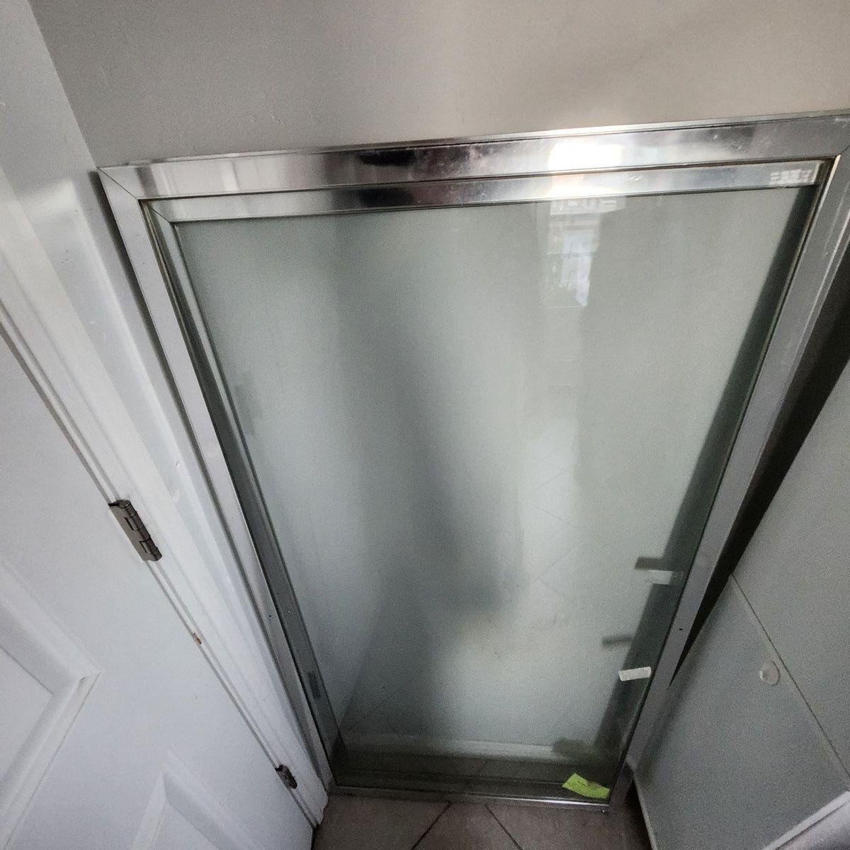 Tempered bathroom sliding glass door.