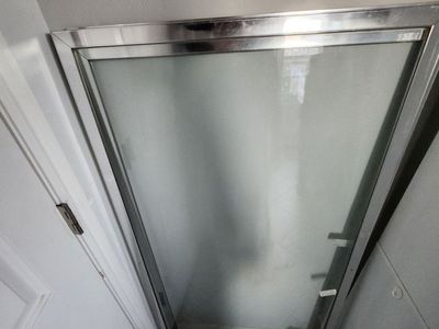 Tempered bathroom sliding glass door.