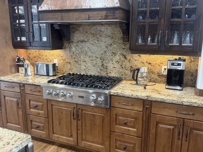 Cabinets - Custom Alderwood glass front with divided light and wavy glass plus Island base cabinets