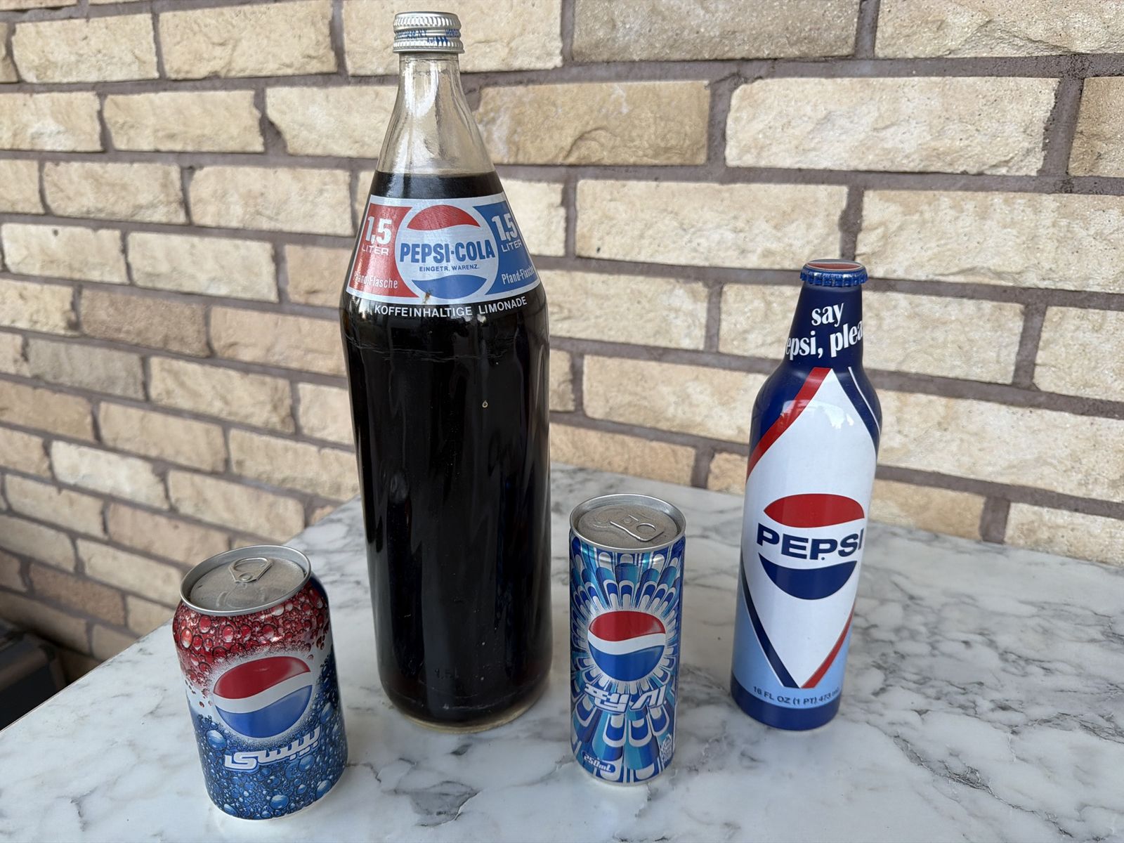 Vintage Pepsi-Cola Collection: 1.5L German Bottle, 16oz "Say Pepsi, Please" Bottle, and Two 250ml Cans