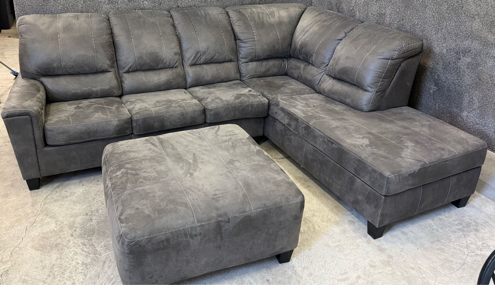 Sectional Sofa in Charcoal Gray in perfect condition. Pet and smoke free home.  We are sad  to see it go. Includes ottoman.