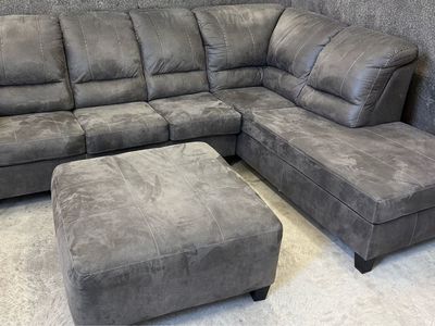 Sectional Sofa in Charcoal Gray in perfect condition. Pet and smoke free home. We are sad to see it go. Includes ottoman.