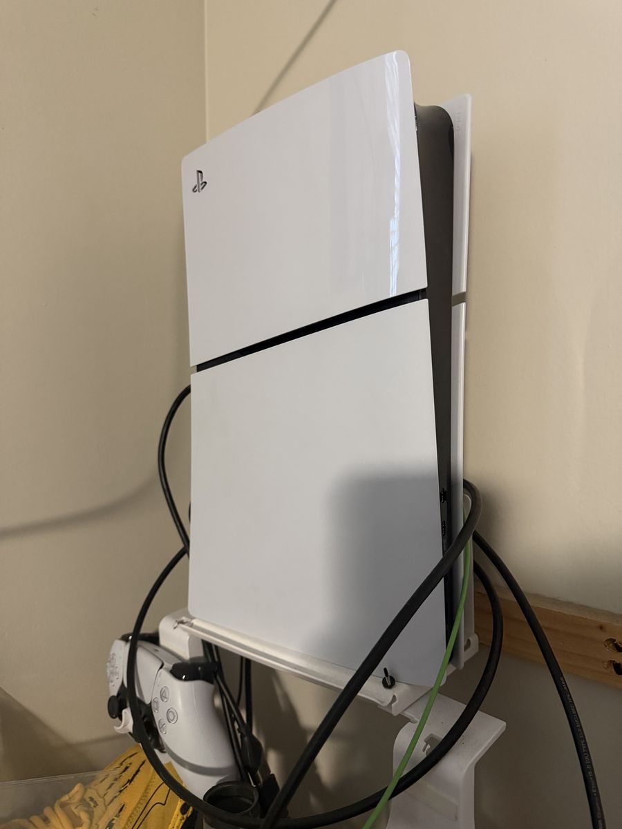 PlayStation 5 with controller and headset.