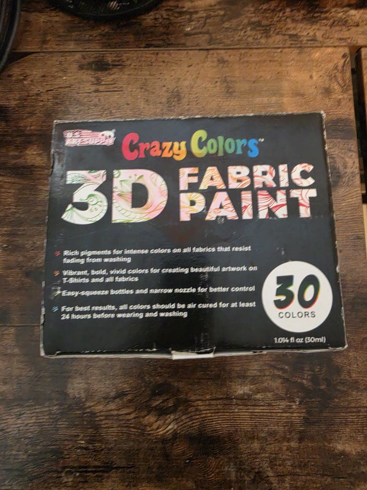 Painting supplies with Fabric Paint, acrylic paint, Puffy paint, and paint brushes