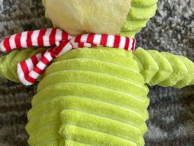 Holiday Time corduroy frog Christmas plush toy featuring a green ribbed body and a red and white striped scarf.