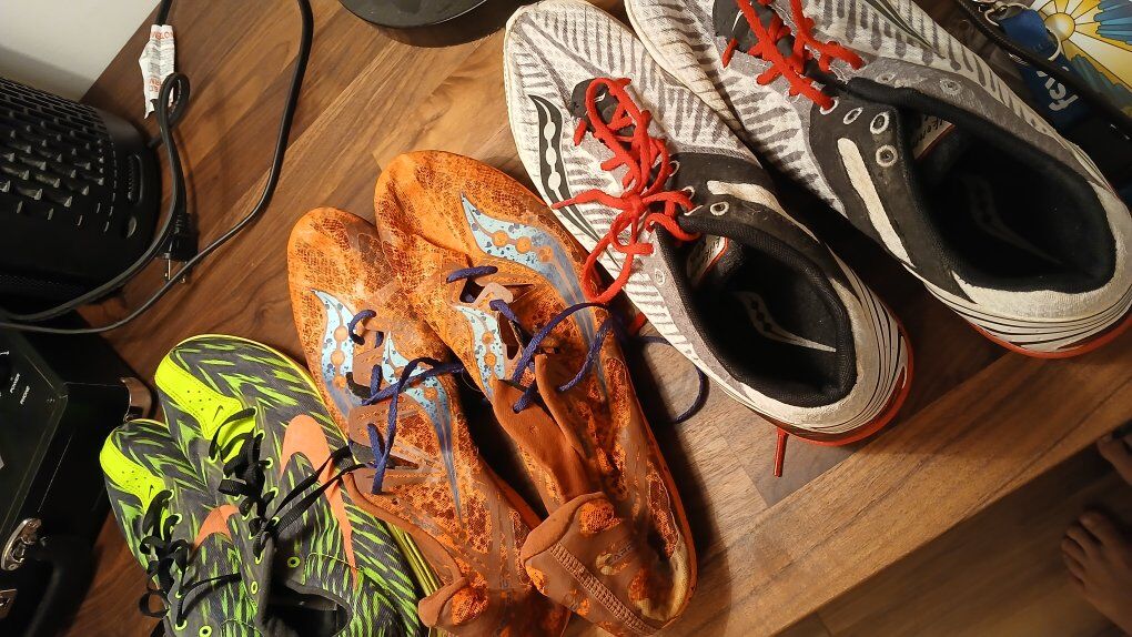 multiple running shoes with spikes for track and