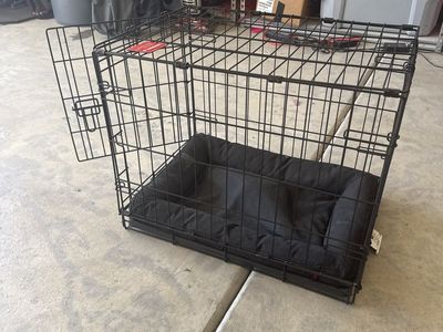 Black Metal Wire Dog Crate with Matching Black Cushion Bed. 24” D × 17” W × 19” H
