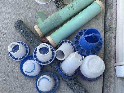 Assorted Poultry Supplies: Feeders, Waterers, Heat Lamps, and Chicken Wire