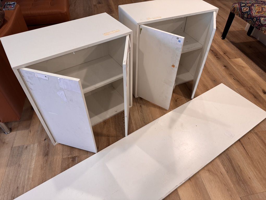 Two Storage Cabinets And Long Board Used As Desk