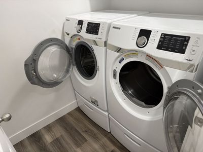 Samsung White Front Load Washer & Electric Dryer Set with Pedestals, Steam Functionality
