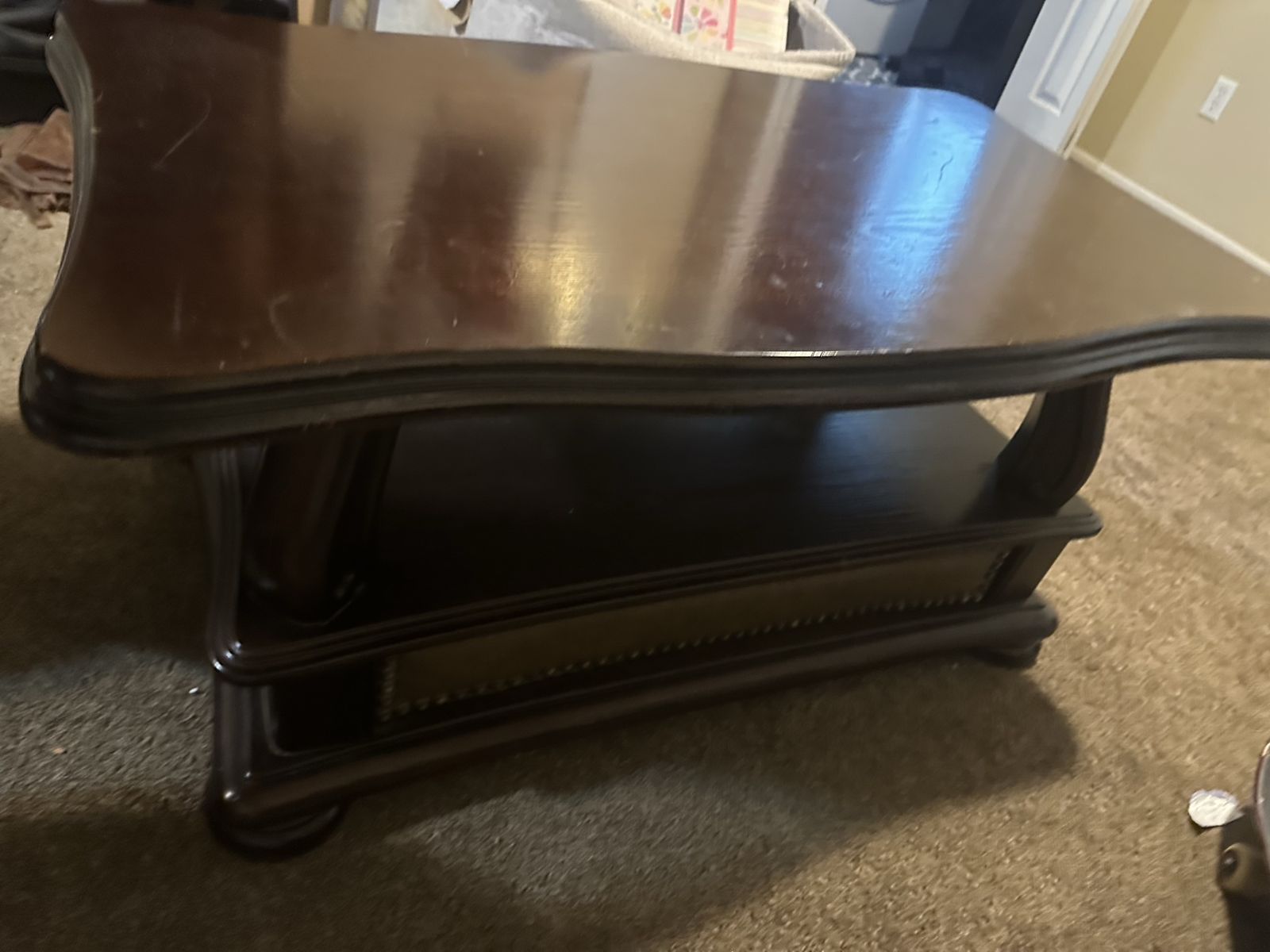 Elegant Dark Wood Coffee Table with Scalloped Edges and Lower Shelf