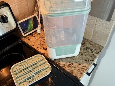Momcozy bottle sterilizer and bottle drying wrack that matches.