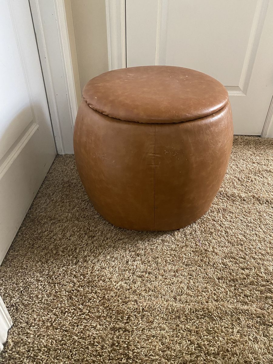 Brown round chair with opening storage ottoman