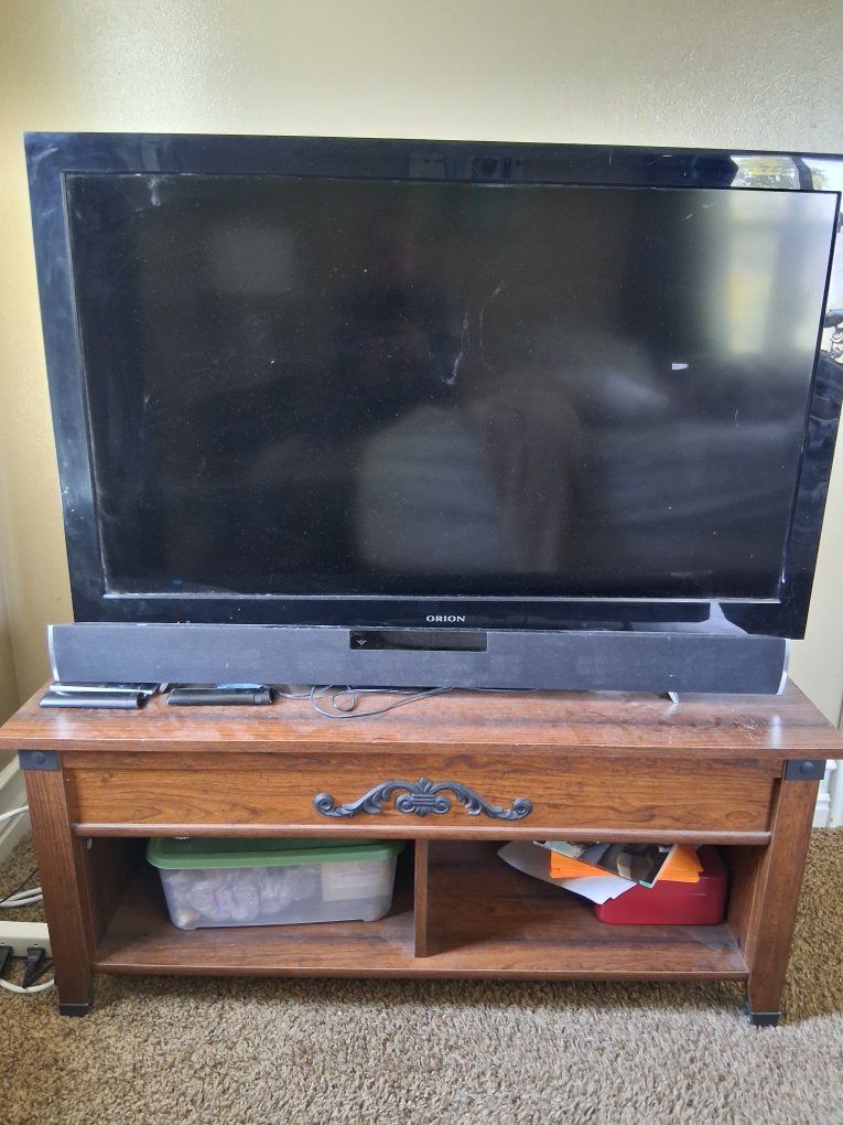 Flat Screen Television with Wooden Coffee Table. Sound bar not included. 