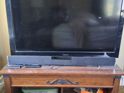 Flat Screen Television with Wooden Coffee Table. Sound bar not included.