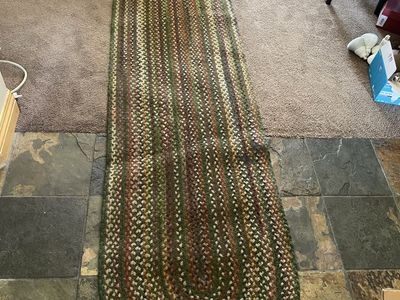 Dark green textured 2.5’x8’ braided rug