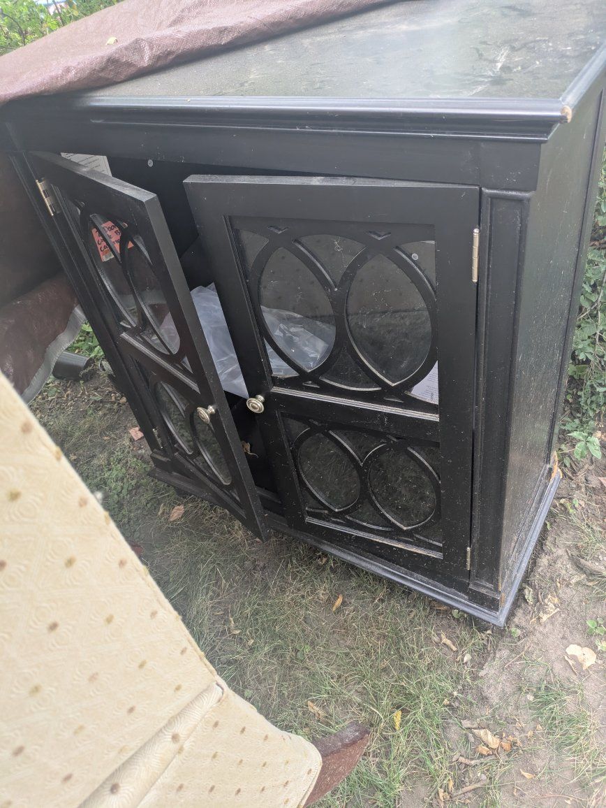Black Accent Cabinet with Glass Doors and Geometric Overlay