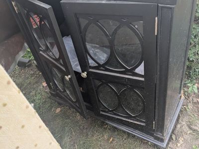 Black Accent Cabinet with Glass Doors and Geometric Overlay