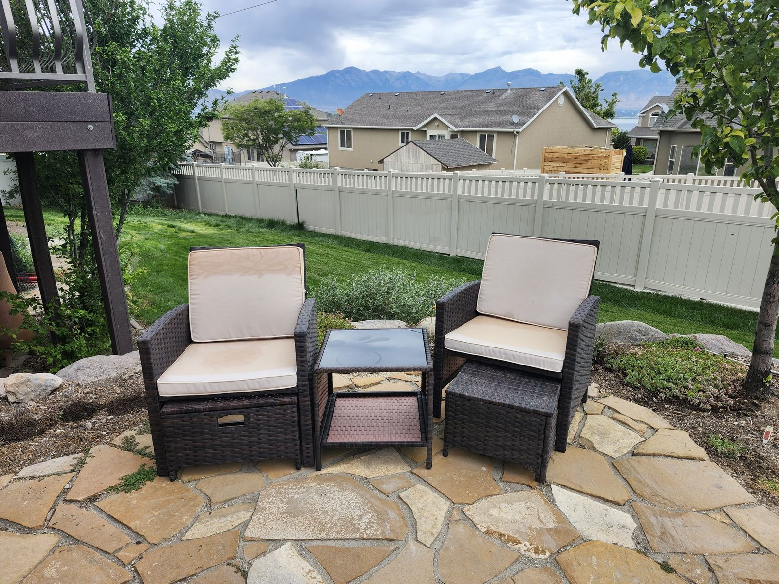 Patio chairs with footstools and drinks table