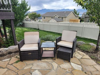 Patio chairs with footstools and drinks table