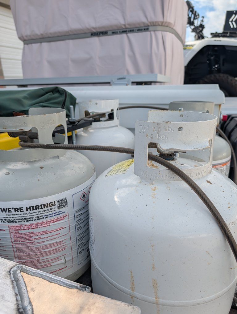 two sets of two propane tanks with holder