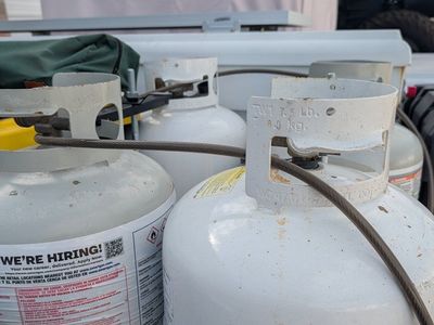 two sets of two propane tanks with holder