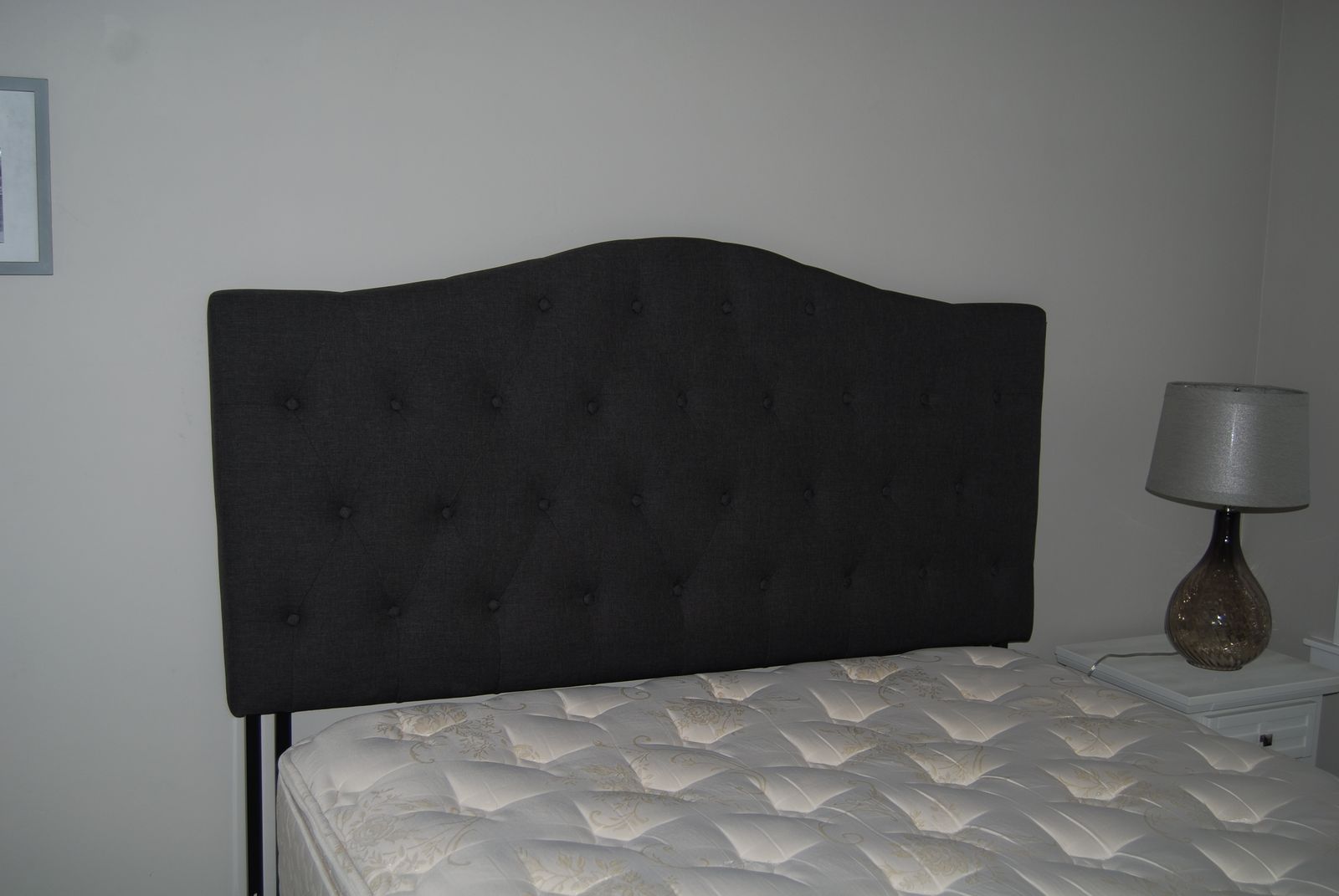 Dark grey upholstered queen sized headboard in very good condition