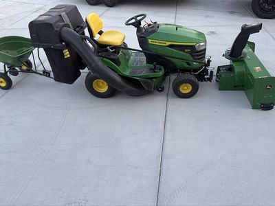 John Deere S120 42in 22hp riding mower with bagger, snowblower, tire chains, & spreader