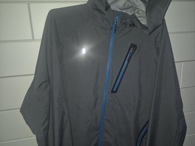 Little Andy Donkey
Unisex Gray Rain Jacket - Medium, Nylon, Reflective Logo, Blue Zippers