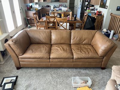 2 beautiful leather couches and ottoman