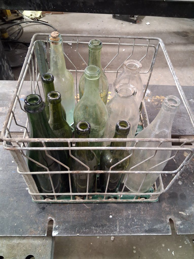 11 OLD BOTTLES and METAL CRATE
