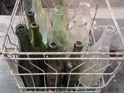 11 OLD BOTTLES and METAL CRATE