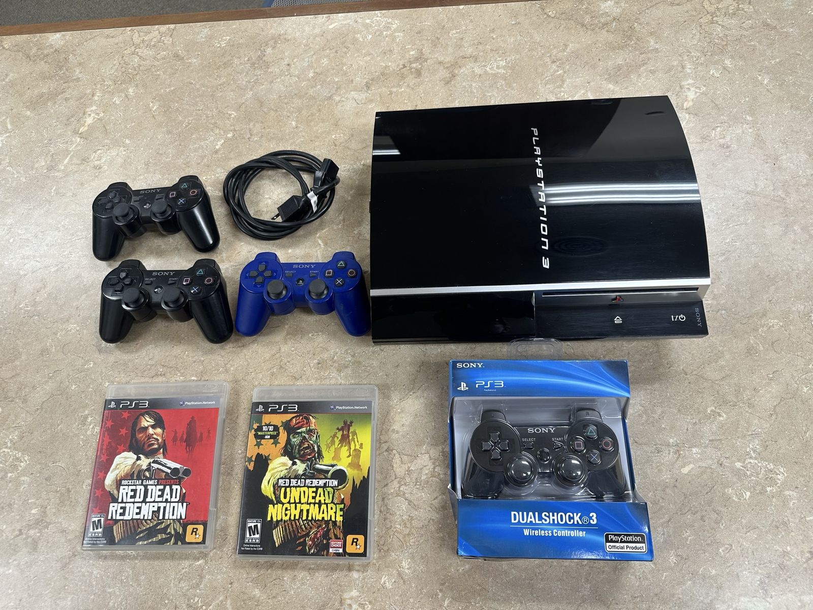 PS3 Console + controllers (1 new) + games